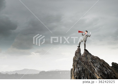 Businessman in hat with trumpet 36242025