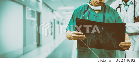 Surgeon and doctor looking at x-ray film. Surgeon and doctor looking at x-ray film. 36244692