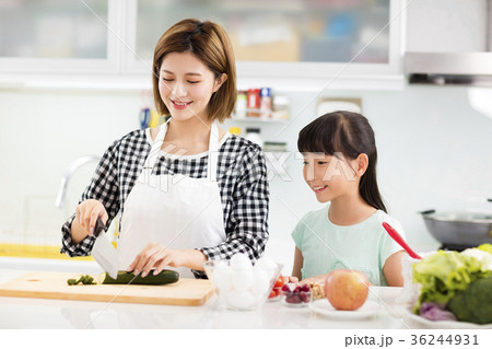 Happy mother and daughter cooking in the kitchen. 36244931