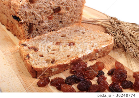 Fresh baked bread, ears of wheat and raisins Fresh baked bread, ears of wheat and raisins 36248774