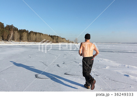 Man with a naked torso running ice of a river Man with a naked torso running ice of a river 36249333