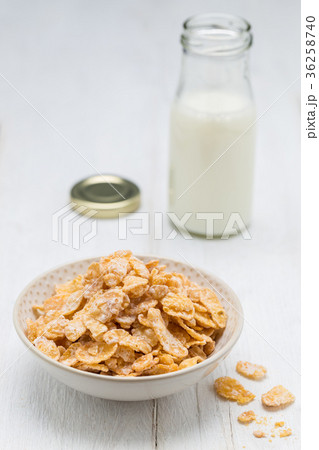 Cornflakes in a bowl and milk bottle Cornflakes in a bowl and milk bottle 36258740