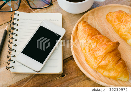 Croissants coffee notebook and smart phone on wood Croissants coffee notebook and smart phone on wood 36259972