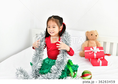 Little girl celebrates Christmas with red Santa dress. 36263459