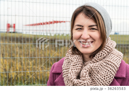 Portrait of a beautiful woman by fence Portrait of a beautiful woman by fence 36263583