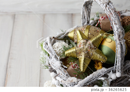 Christmas decorations basket on white planks 36265625