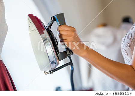 Woman holding iron 36268117