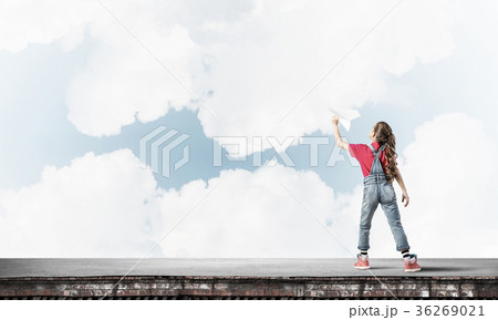 Concept of careless happy childhood with girl dreaming to become 36269021