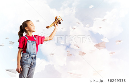 Concept of careless happy childhood with girl throwing retro plane 36269538