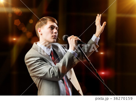 Businessman with microphone 36270159