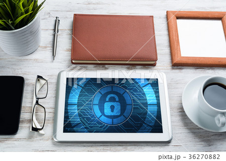 Web security and technology concept with tablet pc on wooden table 36270882