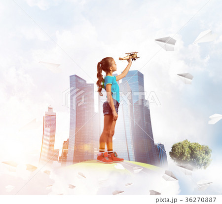 Concept of careless happy childhood with girl dreaming to become pilot 36270887