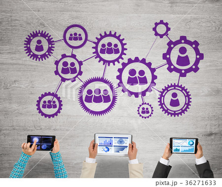 Top view of businesspeople sitting at table and using gadgets Top view of businesspeople sitting at table and using gadgets 36271633