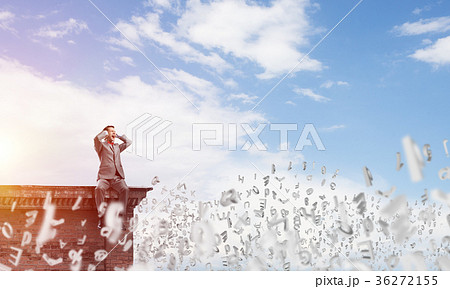 Young man on building edge dont want to hear anything 36272155