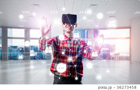 Guy wearing checked shirt and virtual mask reaching hand to touch screen 36273458