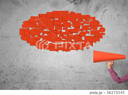 Hand of woman holding green paper trumpet and speech cloud coming out Hand of woman holding green paper trumpet and speech cloud coming out 36273545