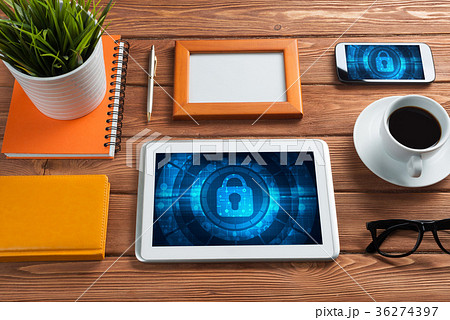 Web security and technology concept with tablet pc on wooden table Web security and technology concept with tablet pc on wooden table 36274397