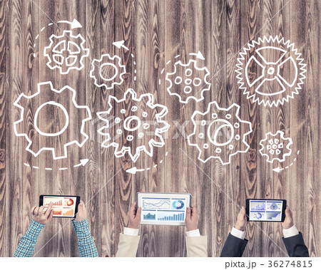 Top view of businesspeople sitting at table and using gadgets 36274815