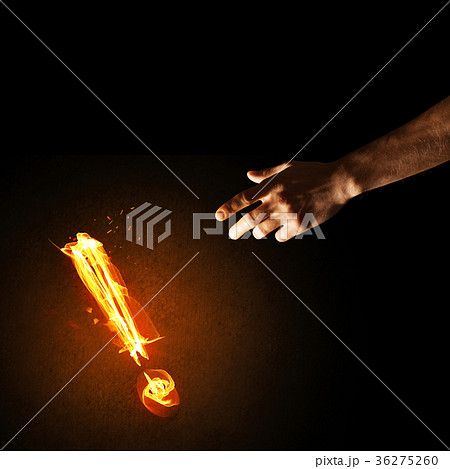 Concept of attention or punctuation with burning exclamation mark on dark background Concept of attention or punctuation with burning exclamation mark on dark background 36275260