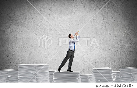 Happy businessman playing fife. 36275287