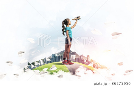 Concept of careless happy childhood with girl dreaming to become 36275950