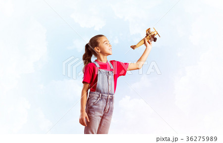 Concept of careless happy childhood with girl dreaming to become pilot 36275989
