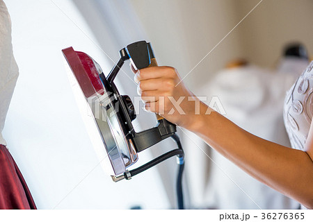 Woman holding iron Woman holding iron 36276365