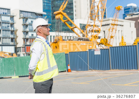 Senior foreman in glasses doing his job at building area on sunny day 36276807