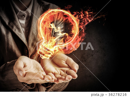 Businessman presenting flaming lightbulb. Businessman presenting flaming lightbulb. 36278216