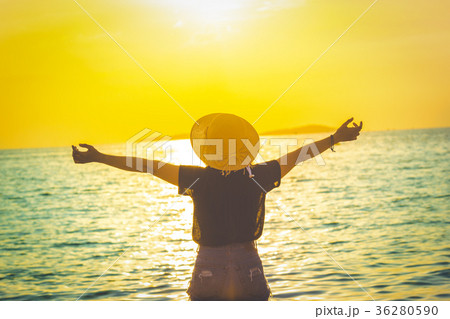 Women enjoying a beautiful sunset on the beach Women enjoying a beautiful sunset on the beach 36280590
