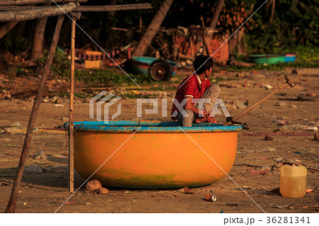Asian Boy in Red T-shirt Sits in Round Orange Boat Asian Boy in Red T-shirt Sits in Round Orange Boat 36281341