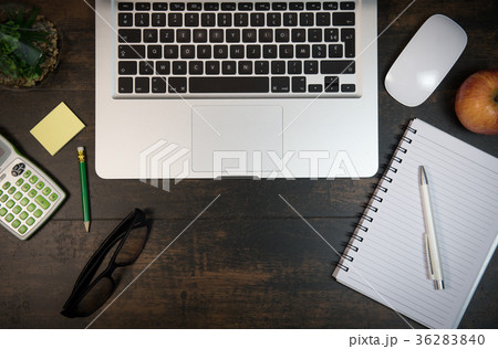 Wood office desk table with laptop and supplies Wood office desk table with laptop and supplies 36283840