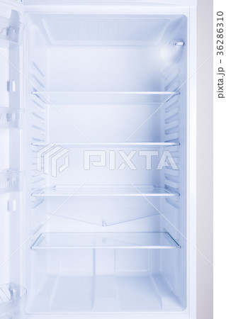 Empty opened modern refrigerator 36286310