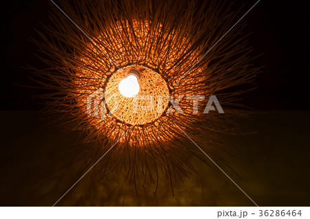 Decorative wicker lamp in dark room. Asian decor Decorative wicker lamp in dark room. Asian decor 36286464