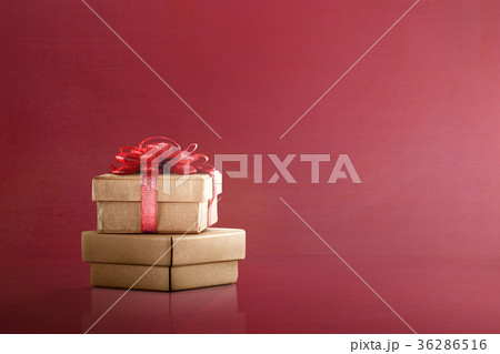 Golden gift box with red ribbon Golden gift box with red ribbon 36286516