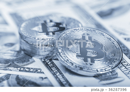 Bitcoins on dollar banknotes background Bitcoins on dollar banknotes background 36287396