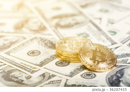 Bitcoins on dollar banknotes background 36287435