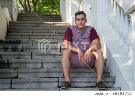 Portrait of stylish man sitting at park on stairs Portrait of stylish man sitting at park on stairs 36293719