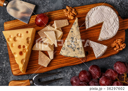 Assorted cheeses on wooden board. Assorted cheeses on wooden board. 36297602