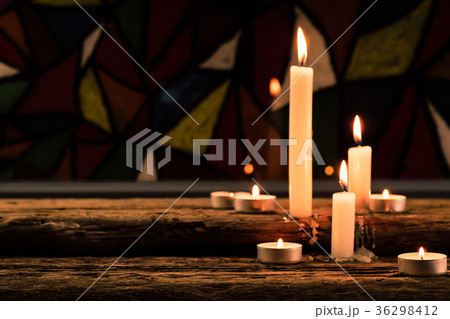 Bible and candle on a old oak wooden table. Bible and candle on a old oak wooden table. 36298412