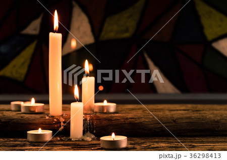 Bible and candle on a old oak wooden table. Bible and candle on a old oak wooden table. 36298413