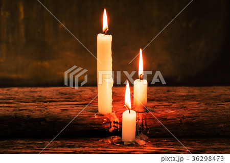 Bible and candle on a old oak wooden table. Bible and candle on a old oak wooden table. 36298473