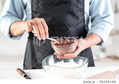 A cook with eggs on a rustic kitchen against the A cook with eggs on a rustic kitchen against the 36299189