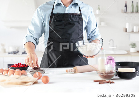 A cook with eggs on a rustic kitchen against the A cook with eggs on a rustic kitchen against the 36299208