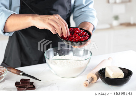 A cook with eggs on a rustic kitchen against the A cook with eggs on a rustic kitchen against the 36299242
