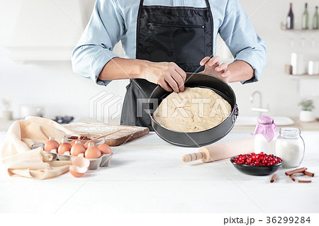 A cook with eggs on a rustic kitchen against the A cook with eggs on a rustic kitchen against the 36299284
