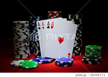 Four aces with a lot of chips on the poker table. Four aces with a lot of chips on the poker table. 36300711
