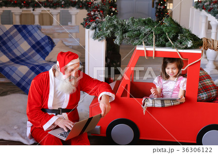 Joyous Santa Claus satisfying with laptop and Joyous Santa Claus satisfying with laptop and 36306122