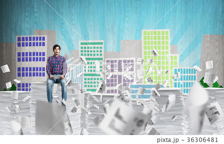 Young man sitting on pile of paper documents. Young man sitting on pile of paper documents. 36306481