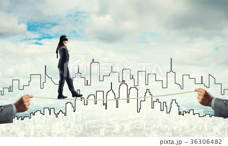 Business concept of risk support and assistance with man balancing on rope 36306482